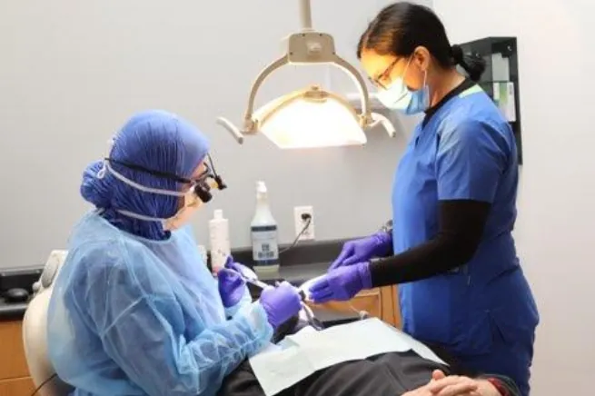 Dentist examining a young patient